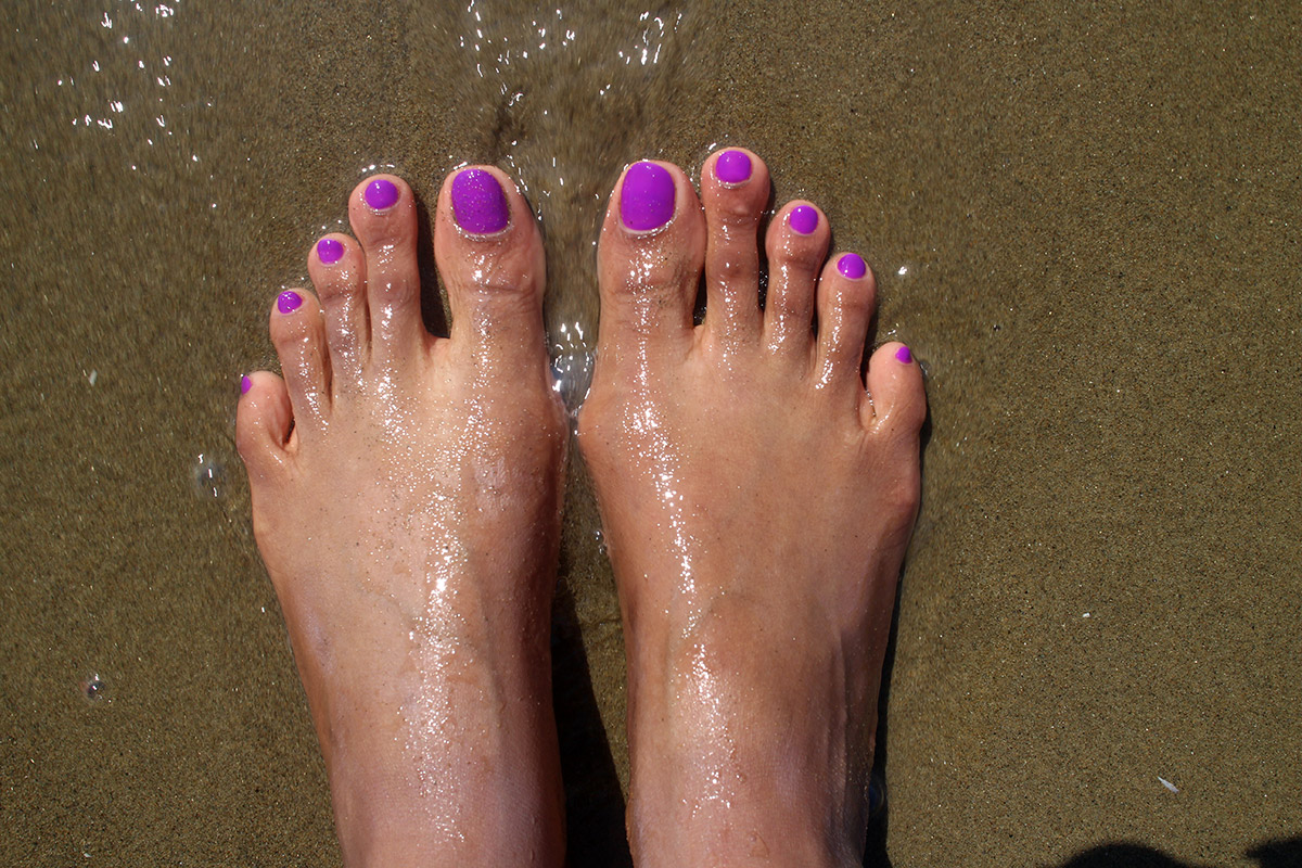 feet on a sandy beach
