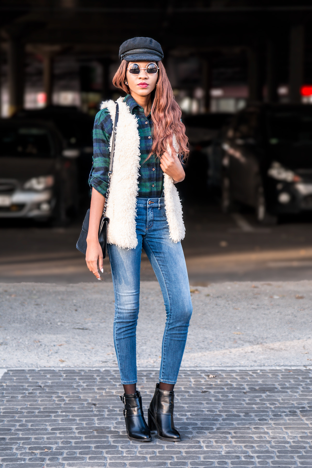 Faux fur gilet on plaid shirt styled with denim jeggings