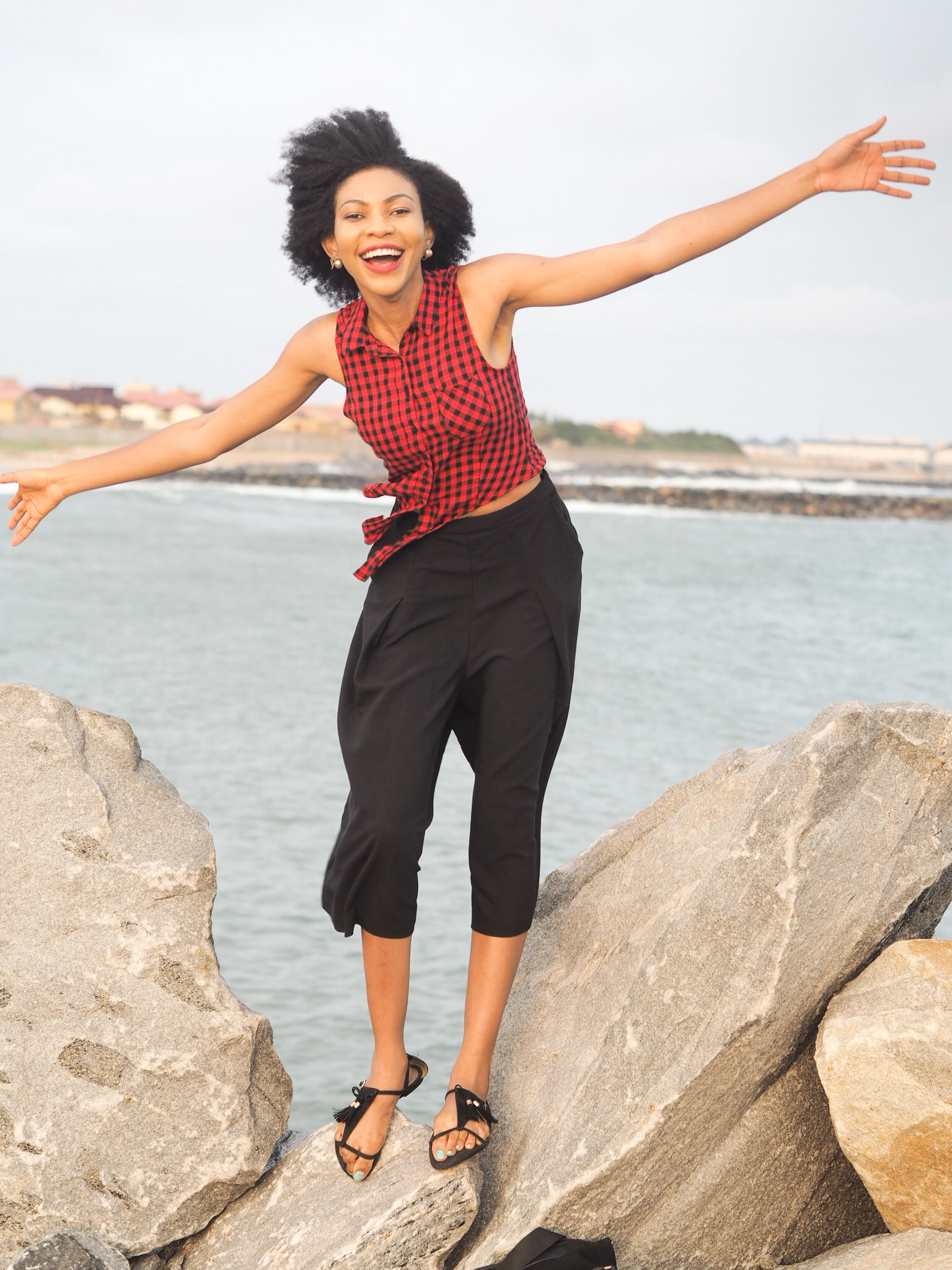 Nigerian blogger Modavracha in red check shirt Travel style outfit