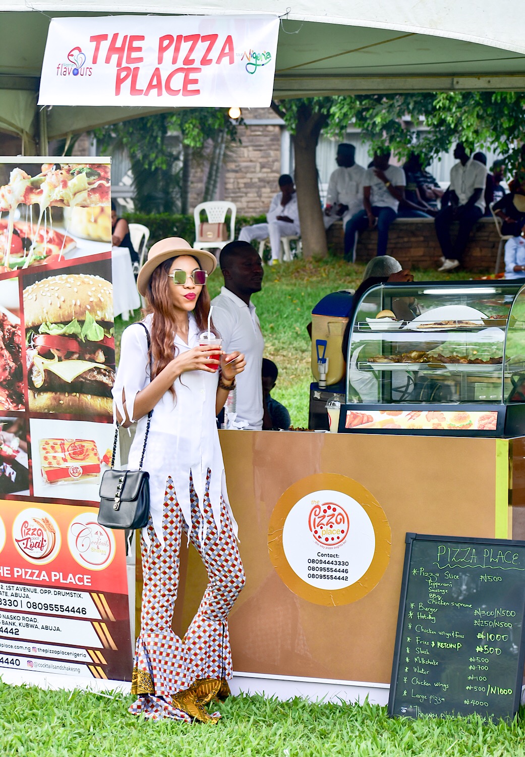 Modavracha having a drink from cocktails and shakes at the pizza place during Nigerian flavours 2018 in Abuja